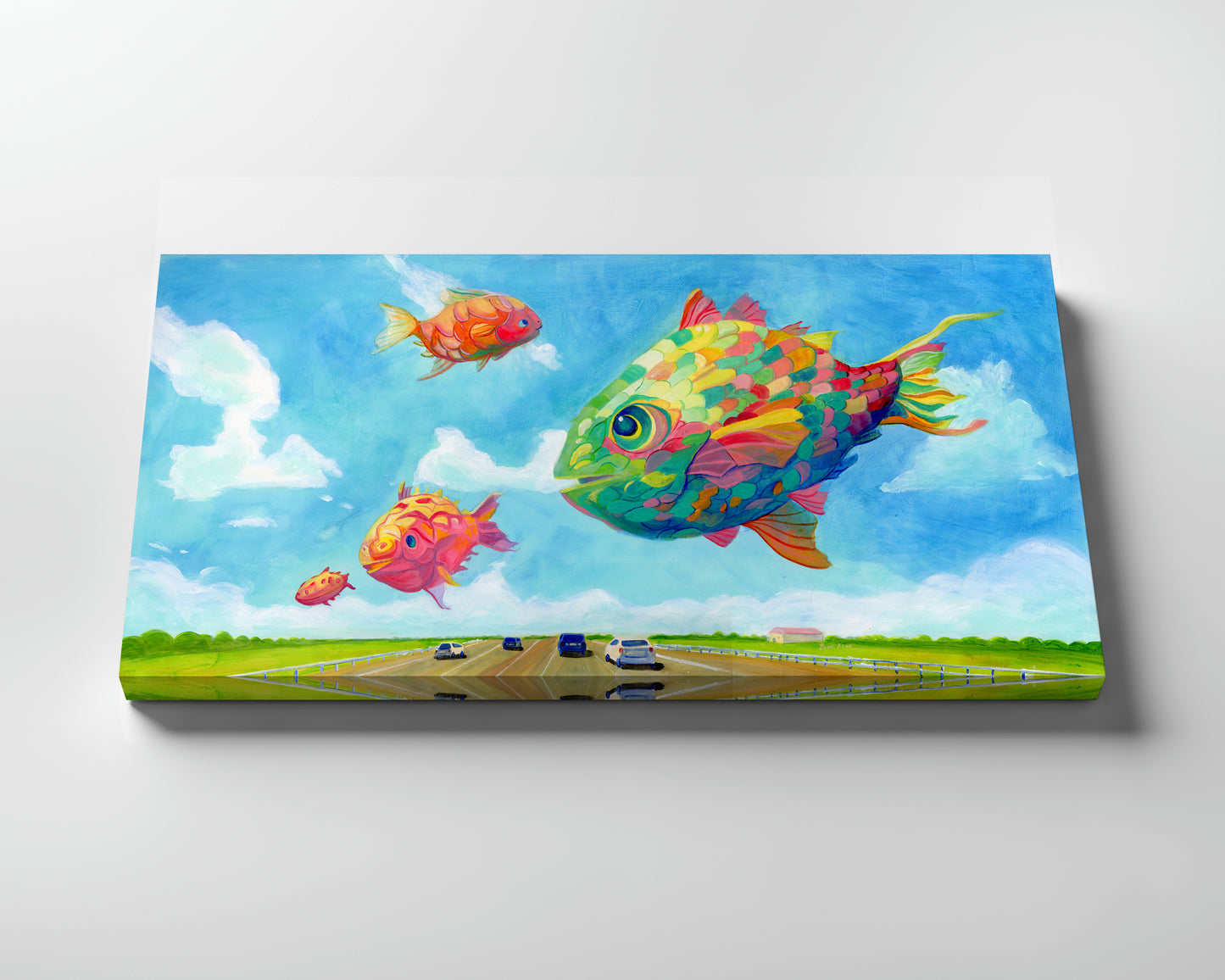 Canvas print of colorful fish over a road with cars, against a blue sky.
